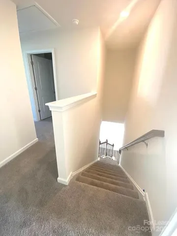 a bathroom with a granite countertop sink a toilet and a mirror