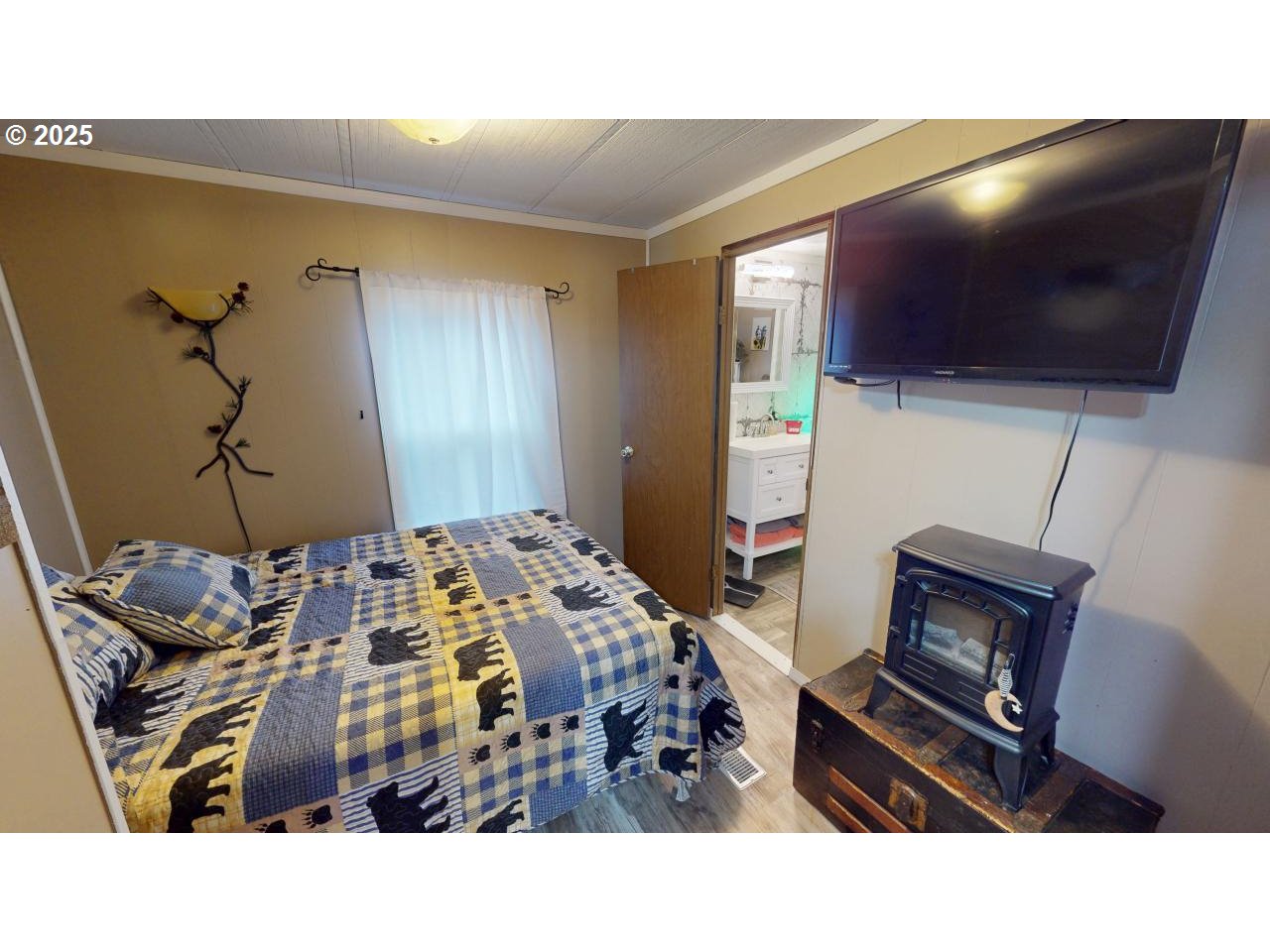 94608 Grange Road Gold Beach, OR 97444 - Photo 13 of 29 a living room with a bed furniture and a flat screen tv