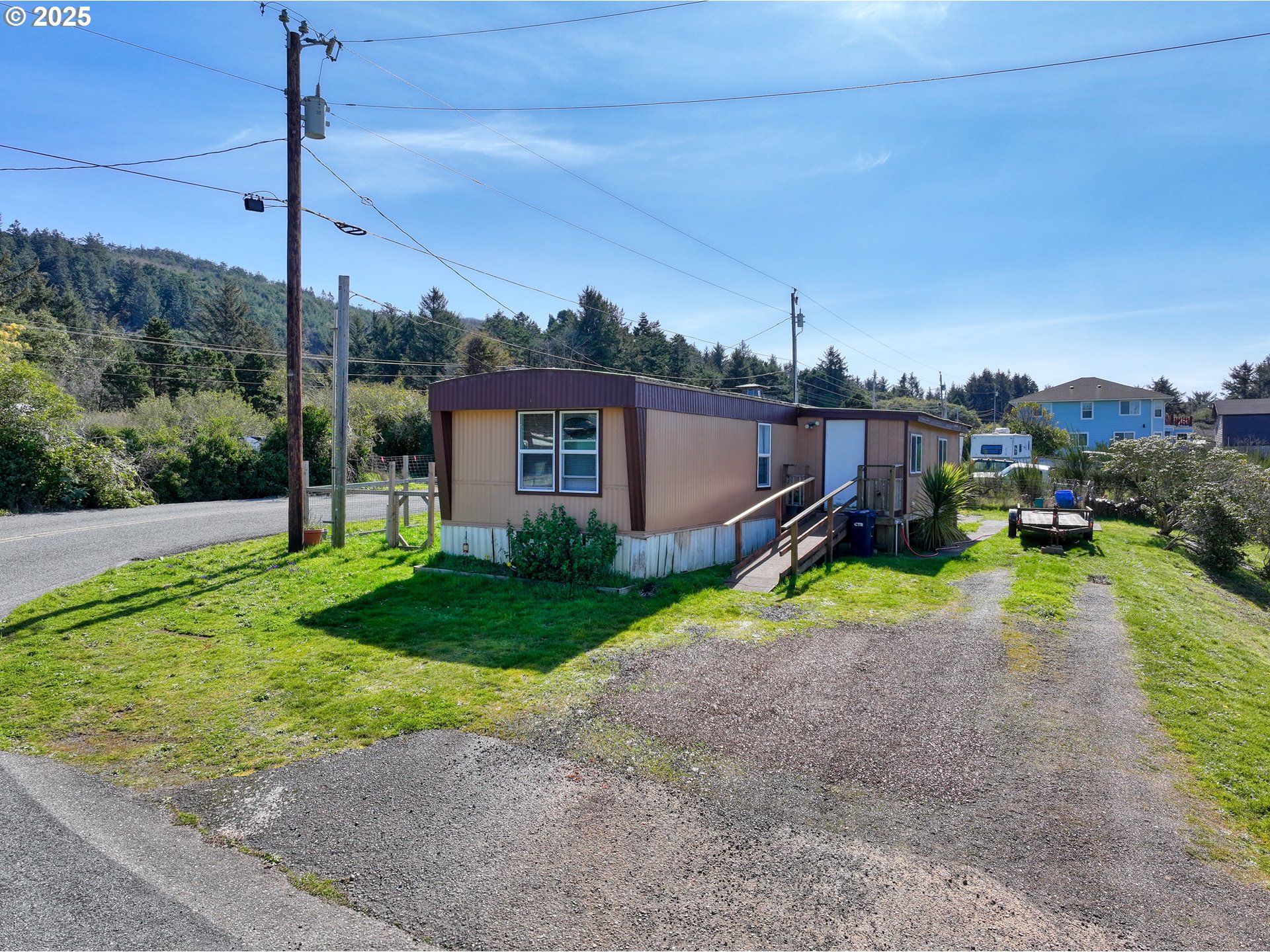 94608 Grange Road Gold Beach, OR 97444 - Photo 24 of 29 a view of a house with a backyard and a tree