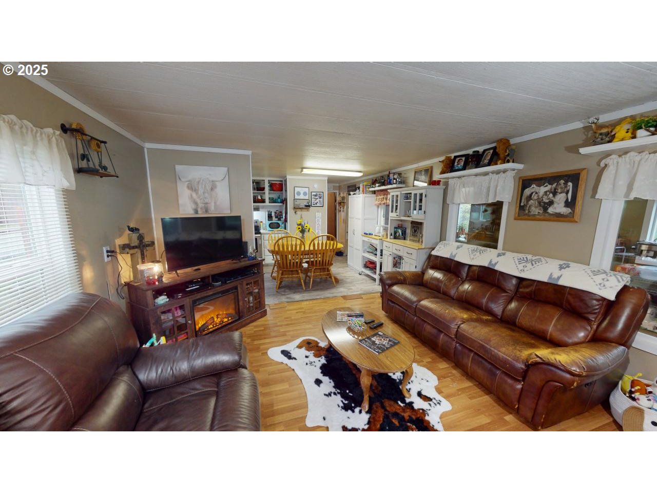 94608 Grange Road Gold Beach, OR 97444 - Photo 4 of 29 a living room with furniture a flat screen tv and a refrigerator