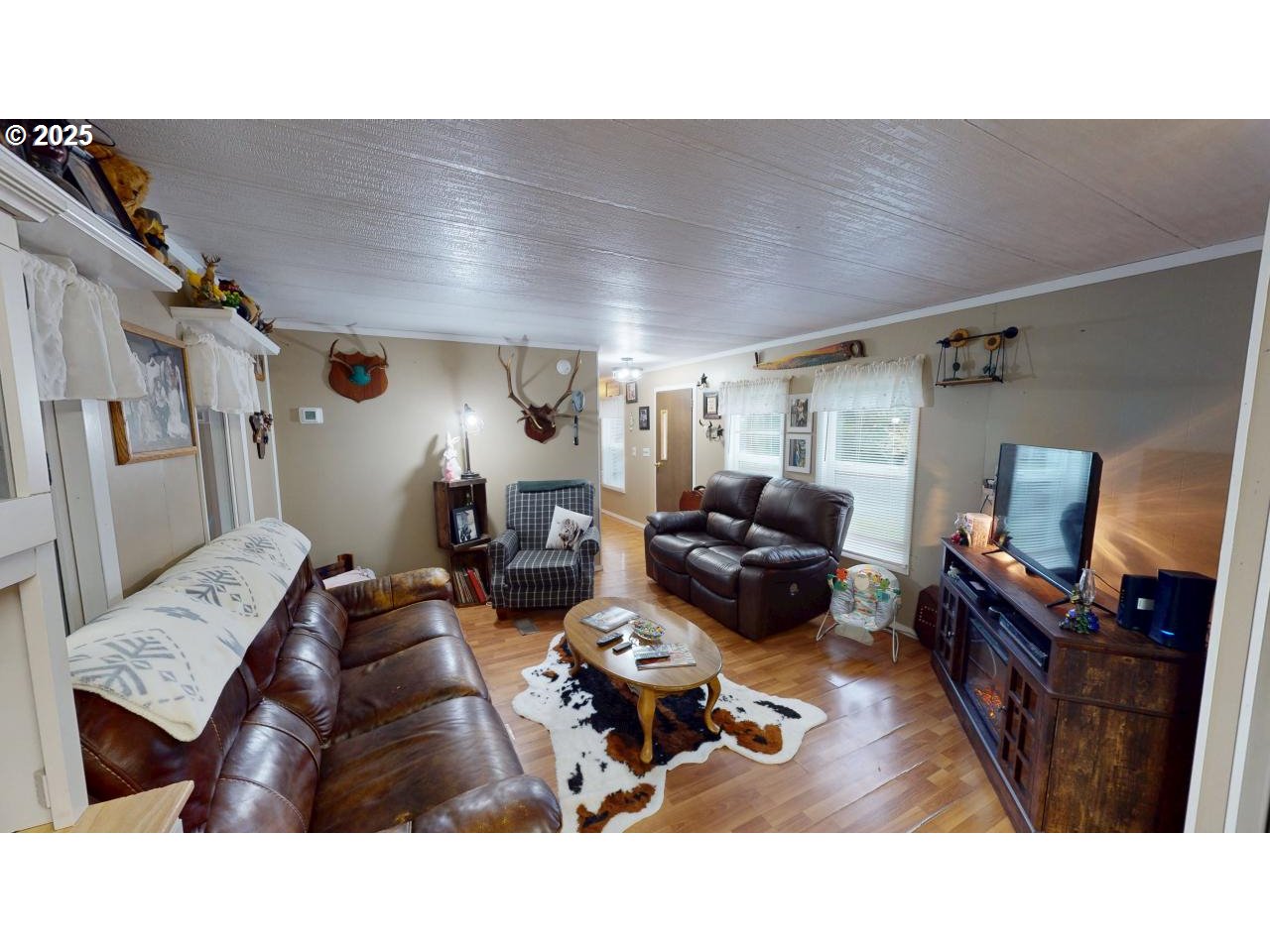 94608 Grange Road Gold Beach, OR 97444 - Photo 5 of 29 a living room with furniture and a flat screen tv
