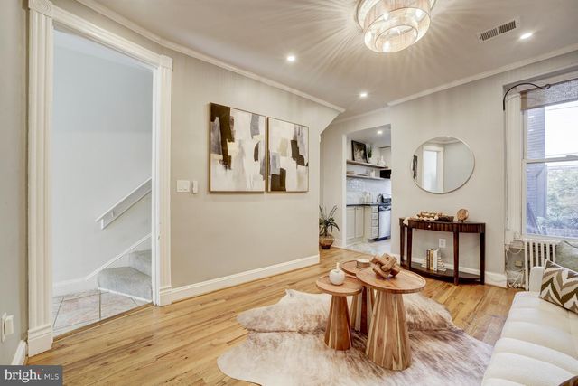 a living room with furniture a mirror and a window