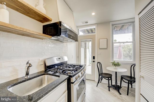 a kitchen that has a sink and a stove