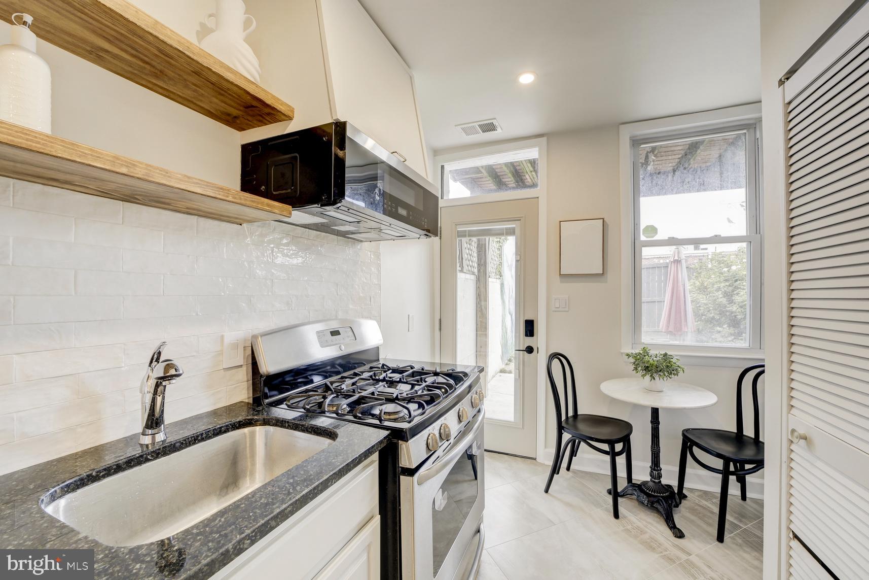 1823 4th Street Northwest Washington, DC 20001 - Photo 14 of 48 a kitchen that has a sink and a stove