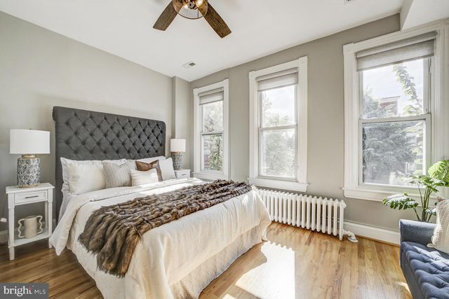 a bedroom with a bed and a chair