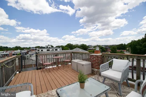 a view of a balcony with wooden floor