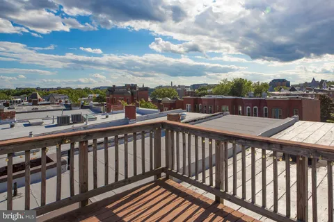 a view of a balcony with wooden fence