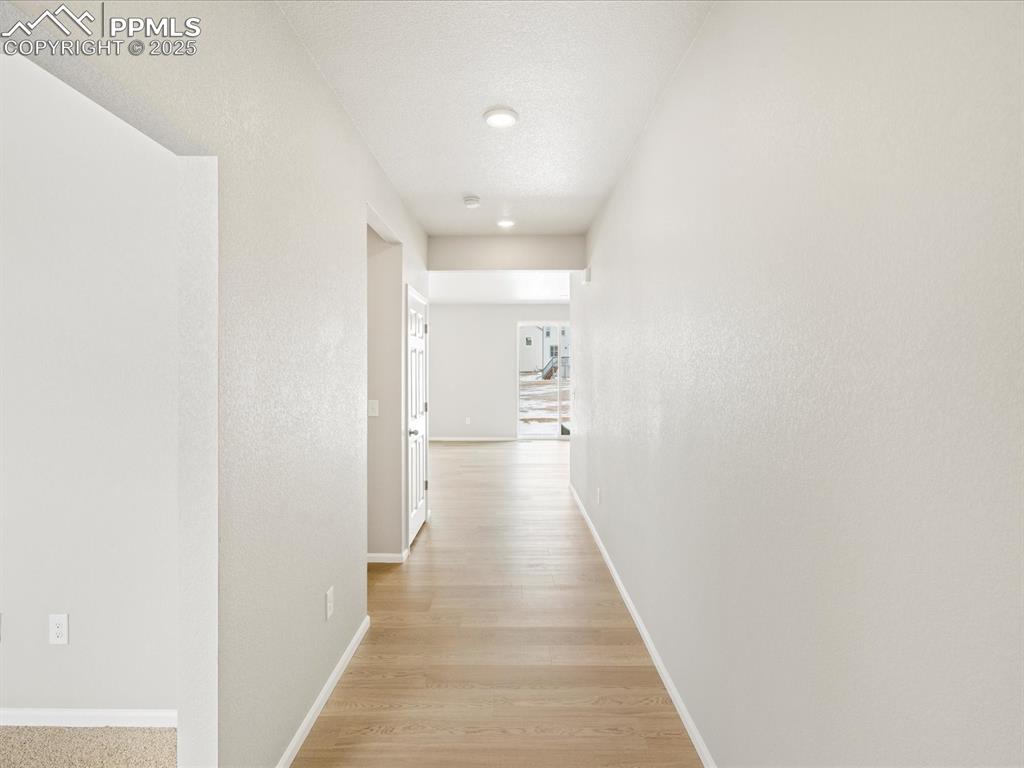 10648 Waterloo Drive Peyton, CO 80831 - Photo 2 of 36 a view of a hallway with wooden floor
