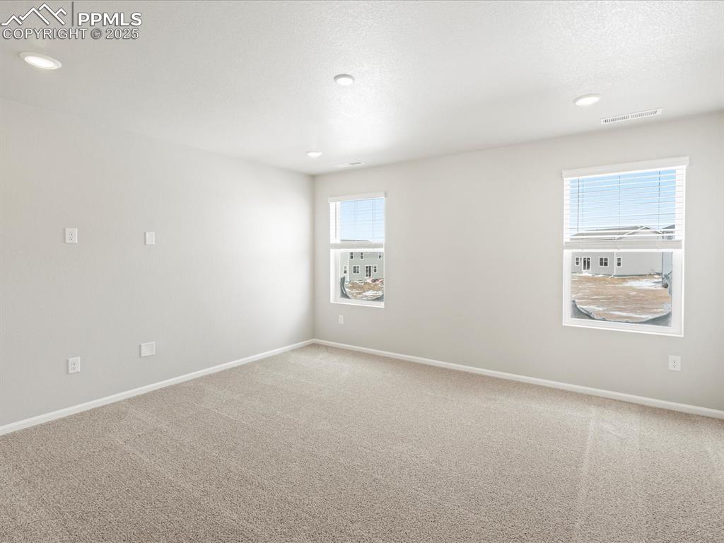 10648 Waterloo Drive Peyton, CO 80831 - Photo 22 of 36 an empty room with windows and closet