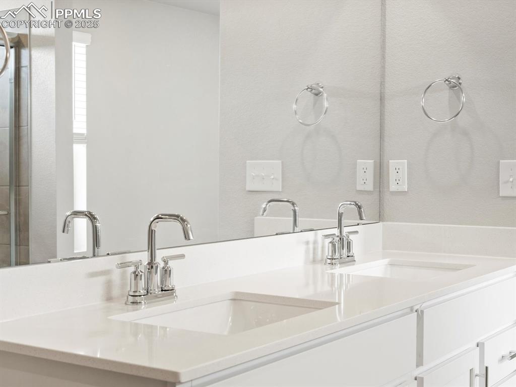 10648 Waterloo Drive Peyton, CO 80831 - Photo 27 of 36 a bathroom with sink and mirror