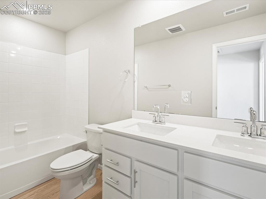 10648 Waterloo Drive Peyton, CO 80831 - Photo 34 of 36 a bathroom with a sink a toilet a mirror and bathtub