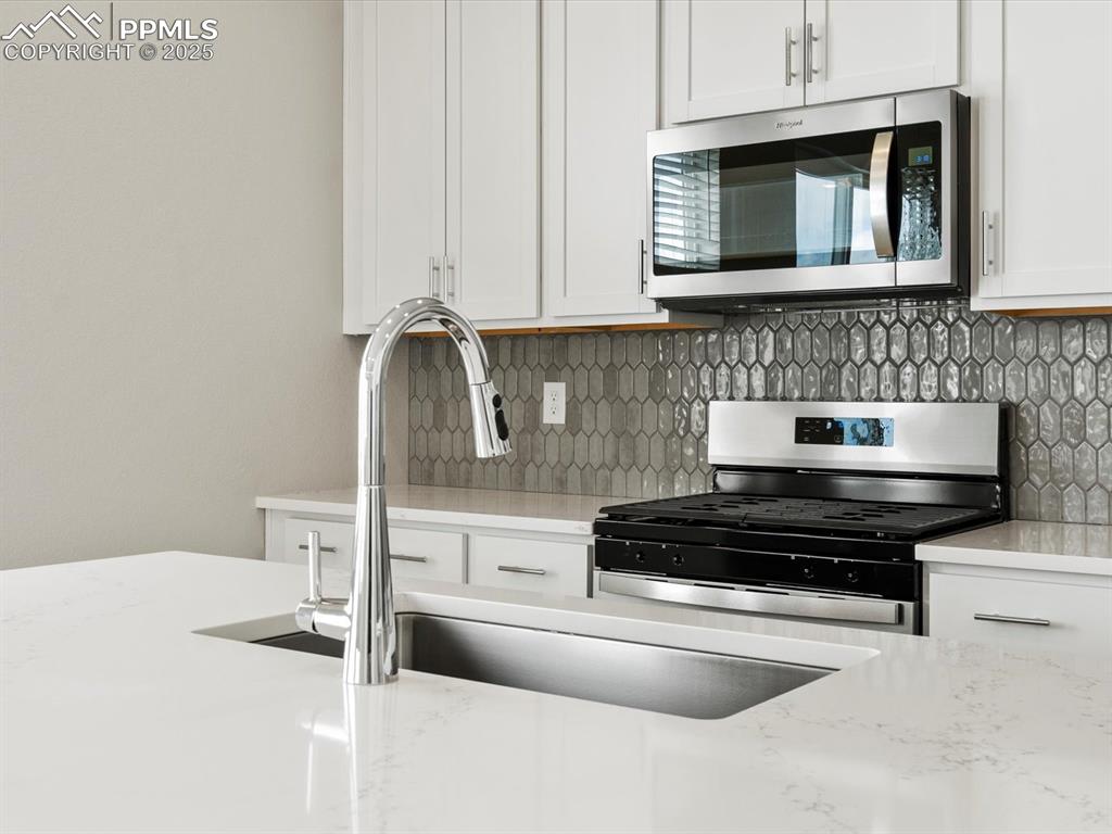 10648 Waterloo Drive Peyton, CO 80831 - Photo 6 of 36 a kitchen with stainless steel appliances granite countertop a sink and cabinets