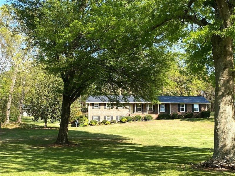 408 Mac Johnson Road Northwest Cartersville, GA 30121 - Photo 1 of 65 a house with swimming pool in front of it