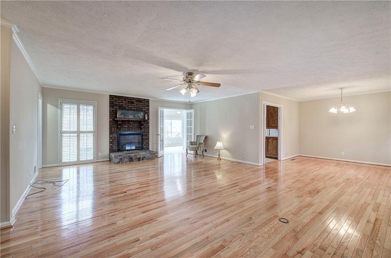 408 Mac Johnson Road Northwest Cartersville, GA 30121 - Photo 12 of 65 a view of an empty room with wooden floor and a window