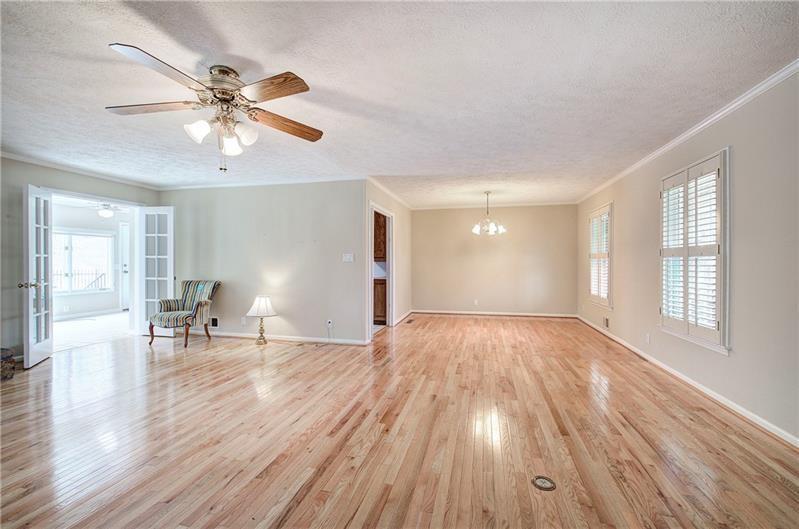 408 Mac Johnson Road Northwest Cartersville, GA 30121 - Photo 13 of 65 a view of empty room with wooden floor and fan