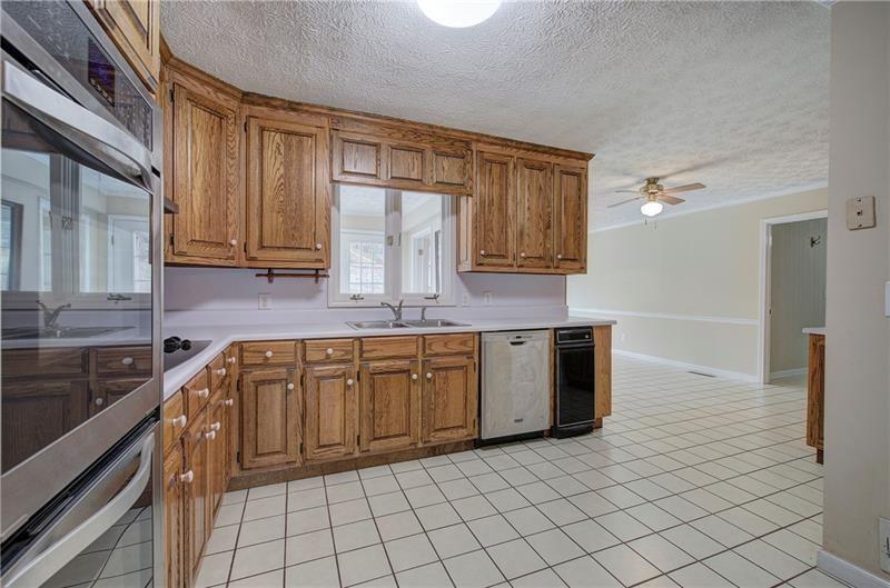 408 Mac Johnson Road Northwest Cartersville, GA 30121 - Photo 19 of 65 a kitchen with stainless steel appliances granite countertop a sink and cabinets