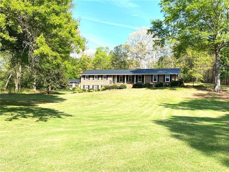 408 Mac Johnson Road Northwest Cartersville, GA 30121 - Photo 2 of 65 a view of a swimming pool with an outdoor space and seating area