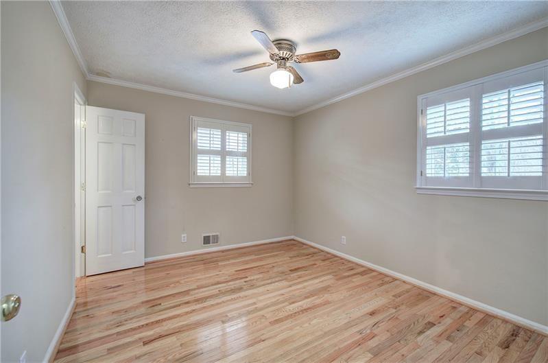 408 Mac Johnson Road Northwest Cartersville, GA 30121 - Photo 35 of 65 an empty room with wooden floor and windows