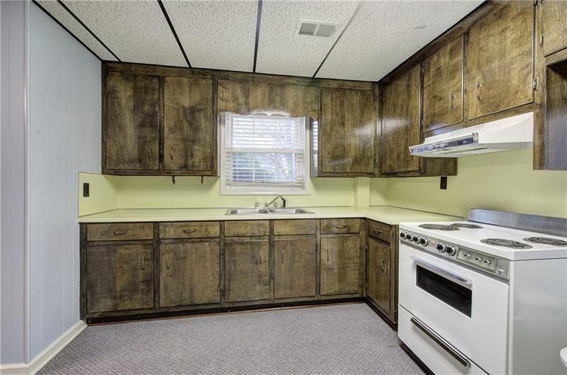 408 Mac Johnson Road Northwest Cartersville, GA 30121 - Photo 47 of 65 a kitchen with a sink stove and cabinets