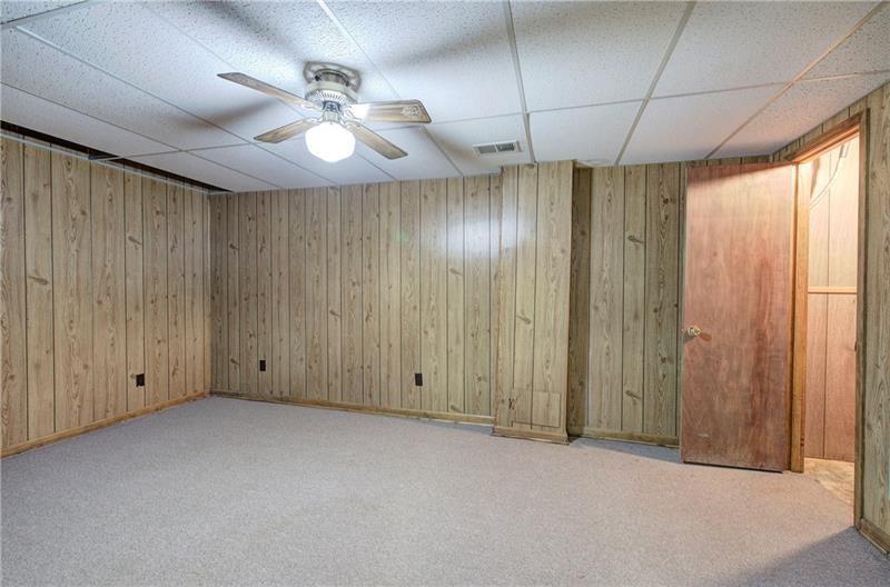 408 Mac Johnson Road Northwest Cartersville, GA 30121 - Photo 48 of 65 an empty room with a chandelier fan and windows