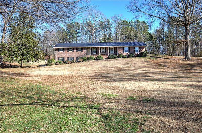 408 Mac Johnson Road Northwest Cartersville, GA 30121 - Photo 5 of 65 a front view of a house with a garden