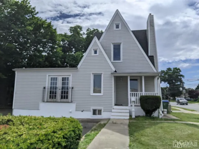 a front view of a house with garden and porch
