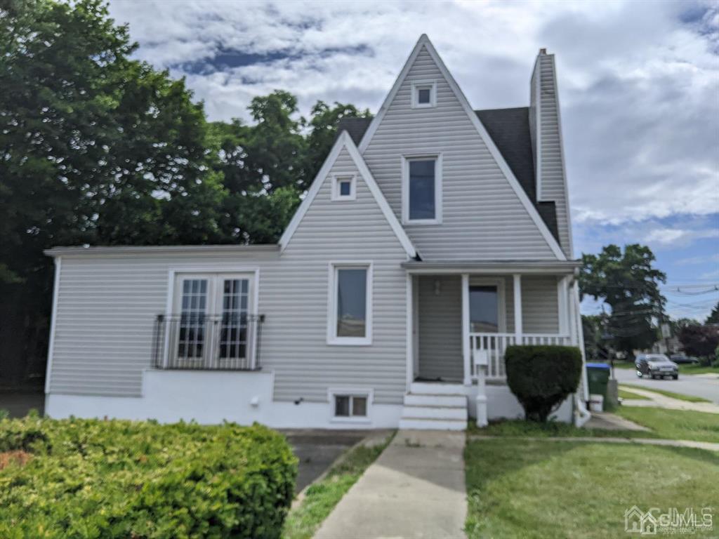 a front view of a house with garden and porch