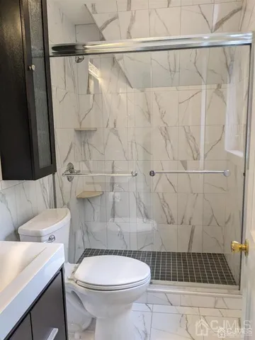 a bathroom with a toilet and a shower
