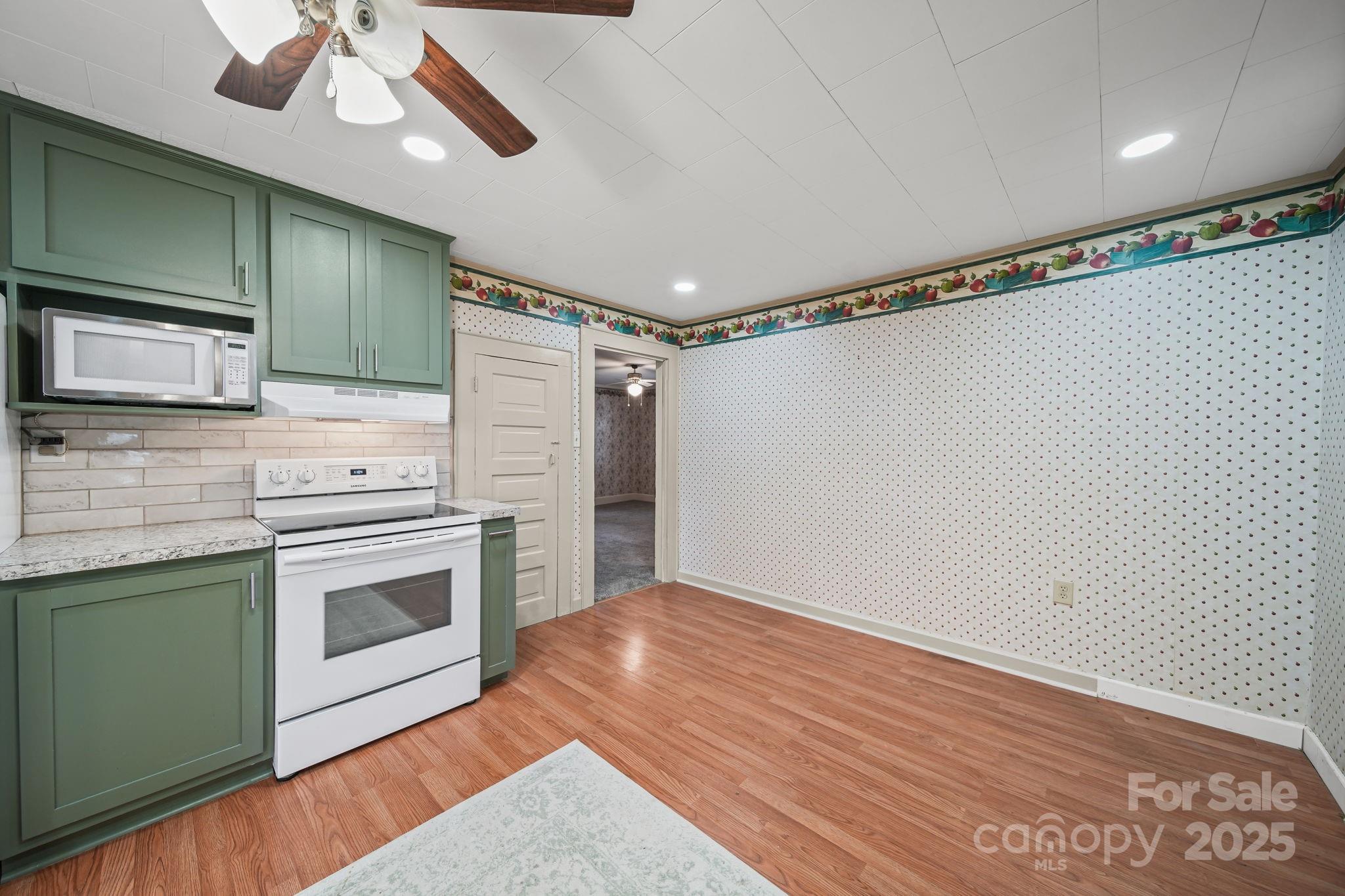 210 Smith Street Clover, SC 29710 - Photo 15 of 33 a kitchen with granite countertop a stove and a microwave