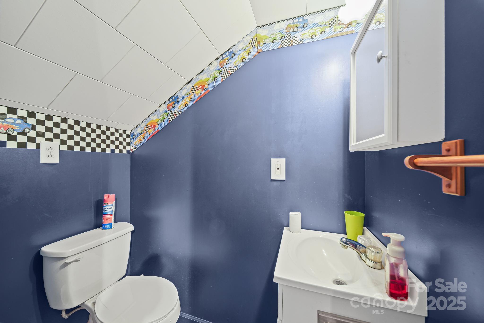 210 Smith Street Clover, SC 29710 - Photo 25 of 33 a white toilet sitting next to a bathroom sink