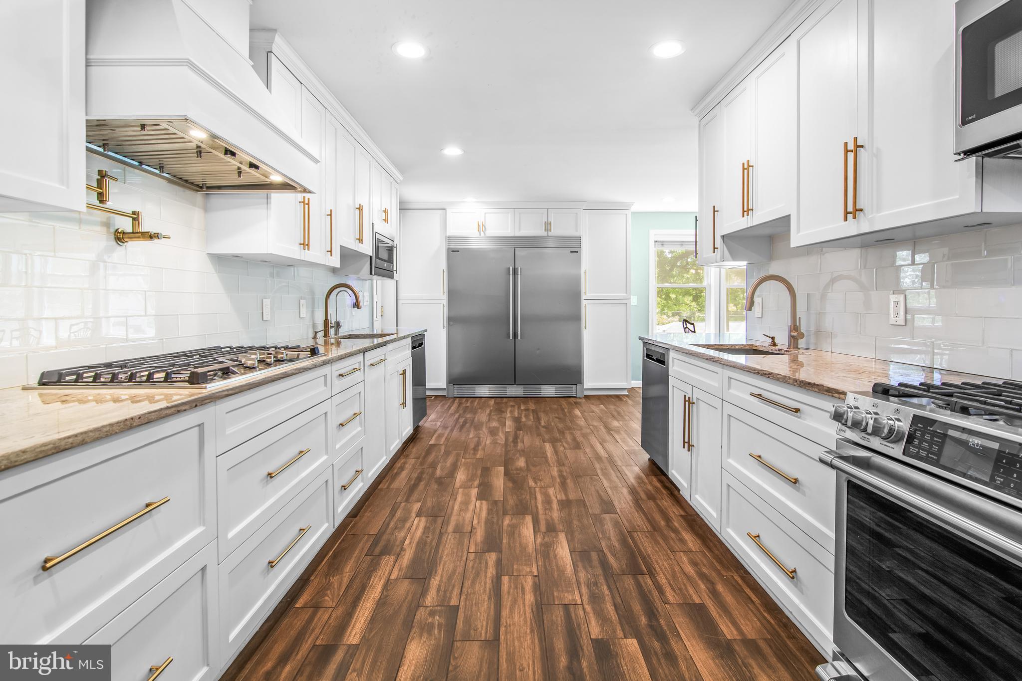 6308 Ivymount Road Baltimore, MD 21209 - Photo 6 of 22 a kitchen with stainless steel appliances granite countertop a stove and a sink