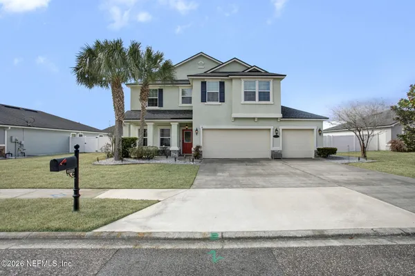 a front view of a house with a yard and garage
