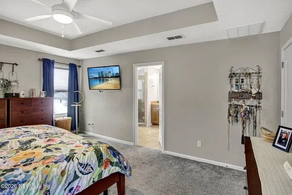 a living room with patio furniture and a flat screen tv