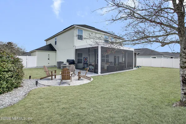 a view of a house with backyard and sitting area