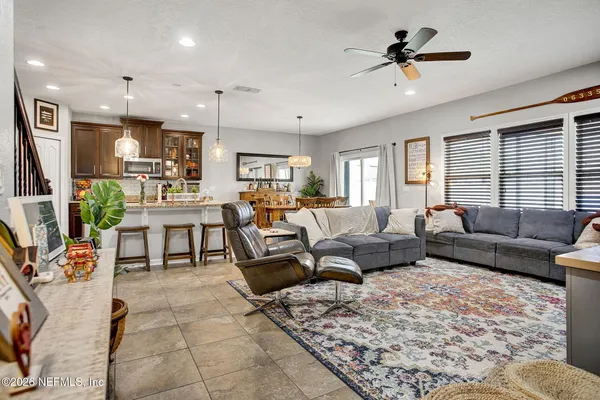 a dining room with furniture window and wooden floor