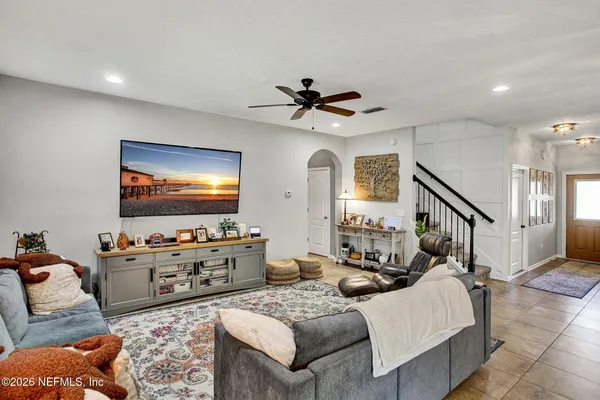 a work room with furniture a rug and a chandelier