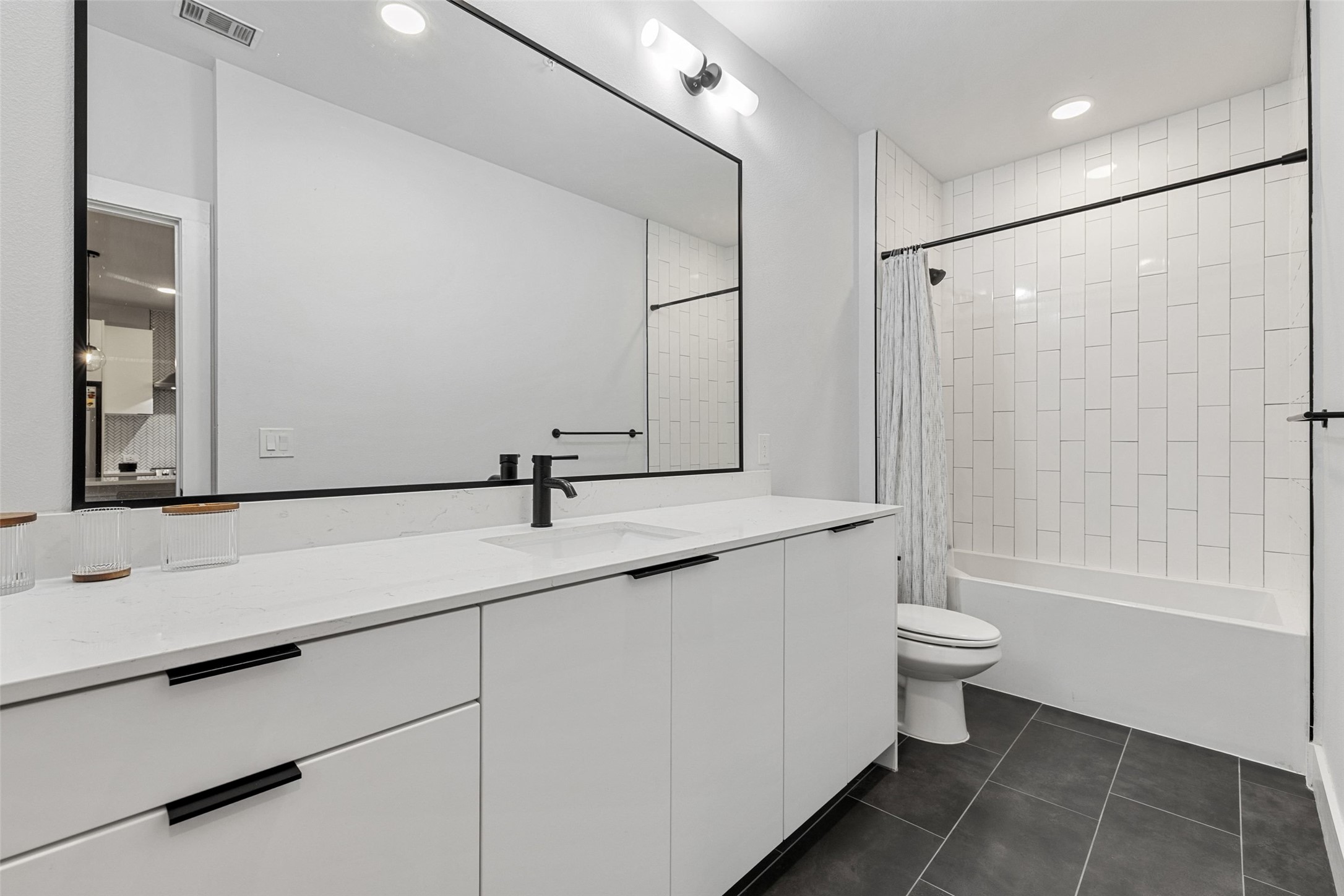 2500 Longview Street, Unit 418 Austin, TX 78705 - Photo 19 of 40 Full bath featuring vanity, shower / bath combo with shower curtain, dark tile patterned floors, and recessed lighting