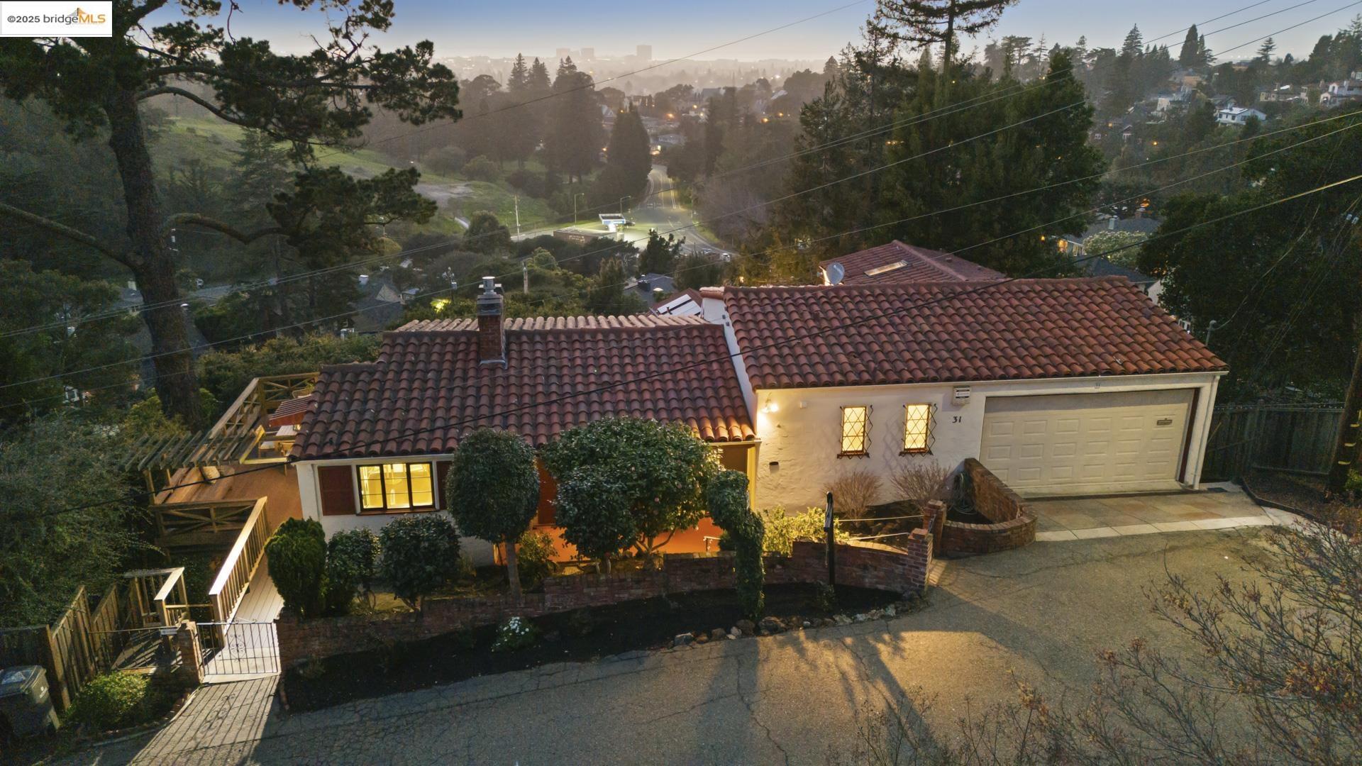 31 Wilding Lane Oakland, CA 94618 - Photo 1 of 1 a view of a patio with table and chairs under an umbrella