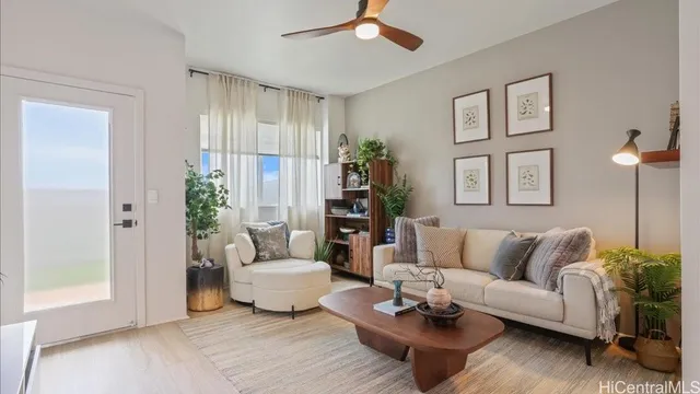 a living room with furniture and a potted plant