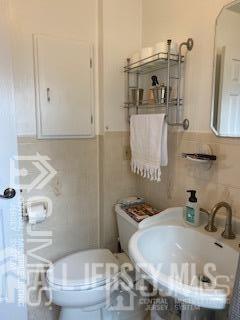 29 Plainfield Avenue Metuchen, NJ 08840 - Photo 5 of 11 a bathroom with a granite countertop sink and a toilet