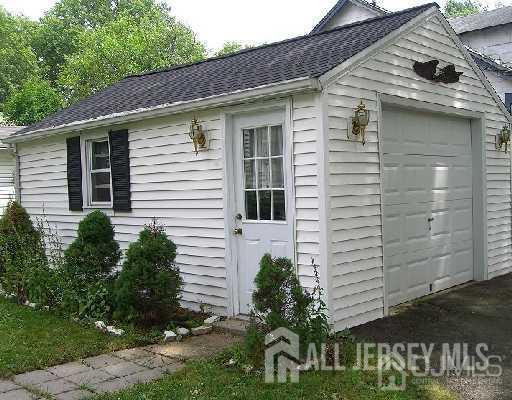 29 Plainfield Avenue Metuchen, NJ 08840 - Photo 9 of 11 a view of a house with a yard and potted plants