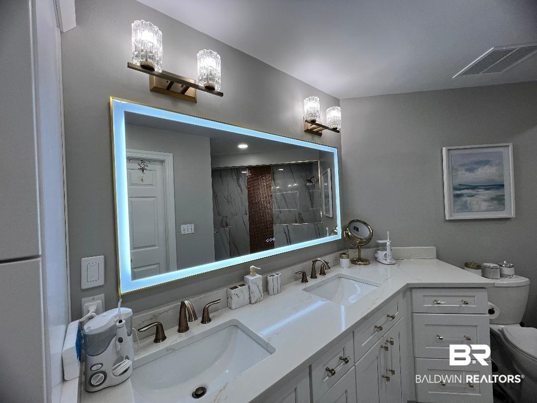 27580 Canal Road, Unit 1210 Orange Beach, AL 36561 - Photo 17 of 28 Bathroom with double vanity and a stall shower