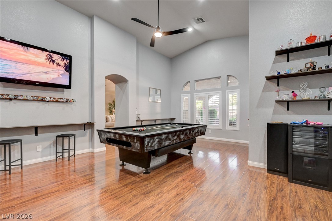 1604 Cattle Ranch Place Henderson, NV 89002 - Photo 15 of 99 Hardwood floors and lofty ceilings create an inviting entertainment zone with a vibrant atmosphere.