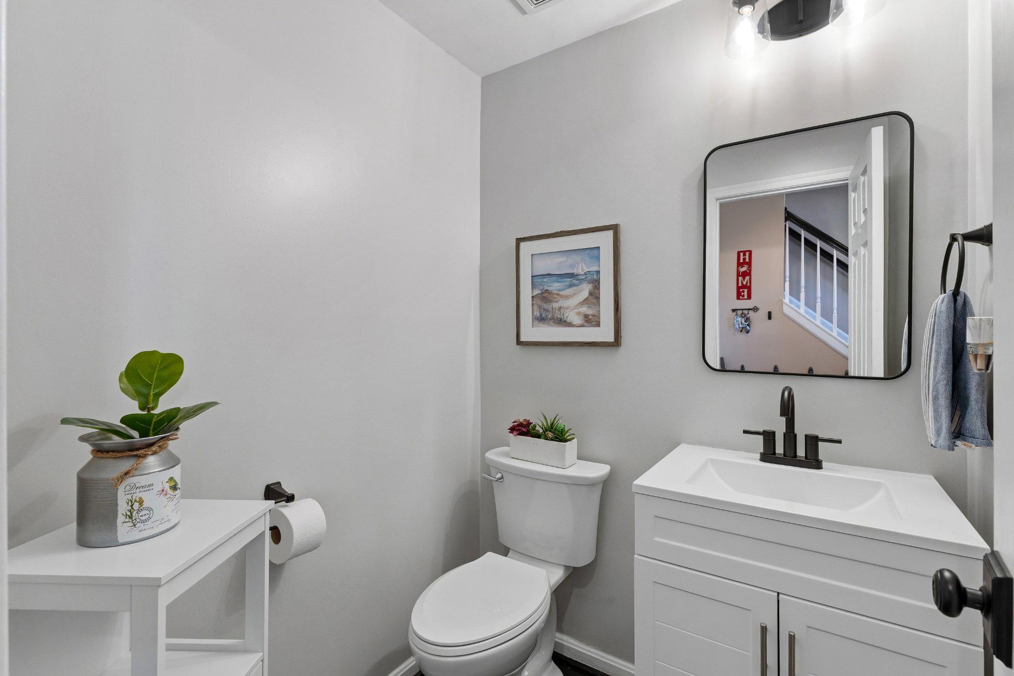 2668 Merlin Court Odenton, MD 21113 - Photo 27 of 42 a bathroom with a toilet sink and mirror