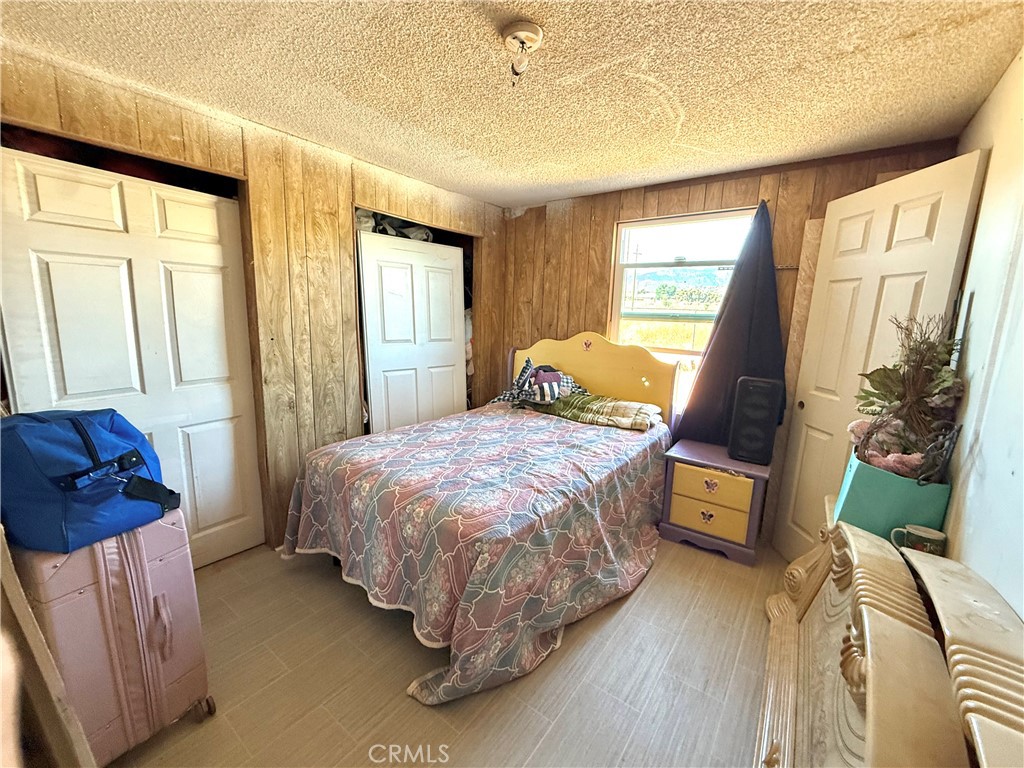 9589 Paramount Road Phelan, CA 92371 - Photo 18 of 29 a bed sitting in a bedroom next to a window