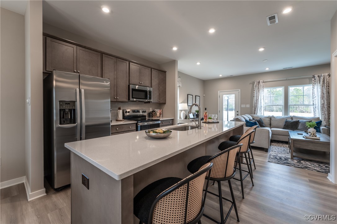 3413 Hopkins Road Richmond, VA 23234 - Photo 6 of 25 a kitchen with a dining table chairs and refrigerator