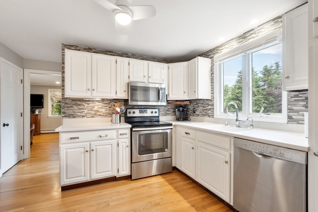 11 Sycamore Road Scituate, MA 02066 - Photo 15 of 39 a kitchen with white cabinets appliances a sink and a window