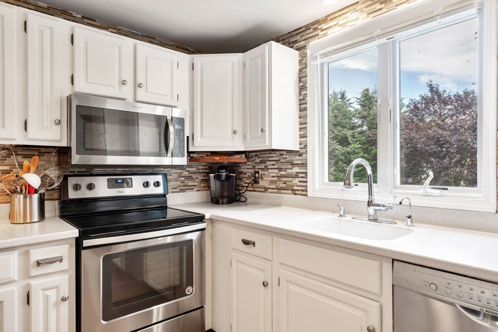 11 Sycamore Road Scituate, MA 02066 - Photo 16 of 39 a kitchen with granite countertop white cabinets white stainless steel appliances and a sink