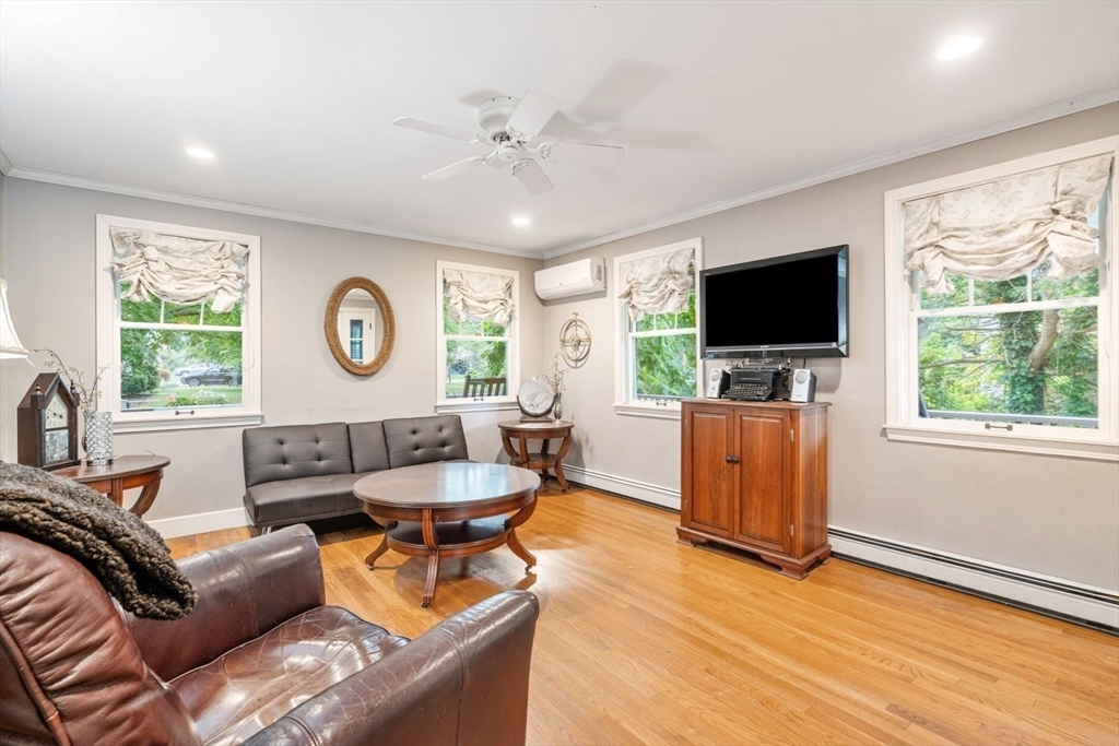 11 Sycamore Road Scituate, MA 02066 - Photo 18 of 39 a living room with furniture and a flat screen tv