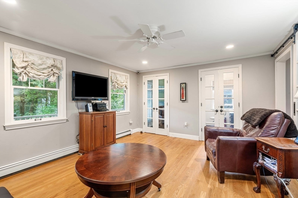 11 Sycamore Road Scituate, MA 02066 - Photo 20 of 39 a living room with furniture and a flat screen tv